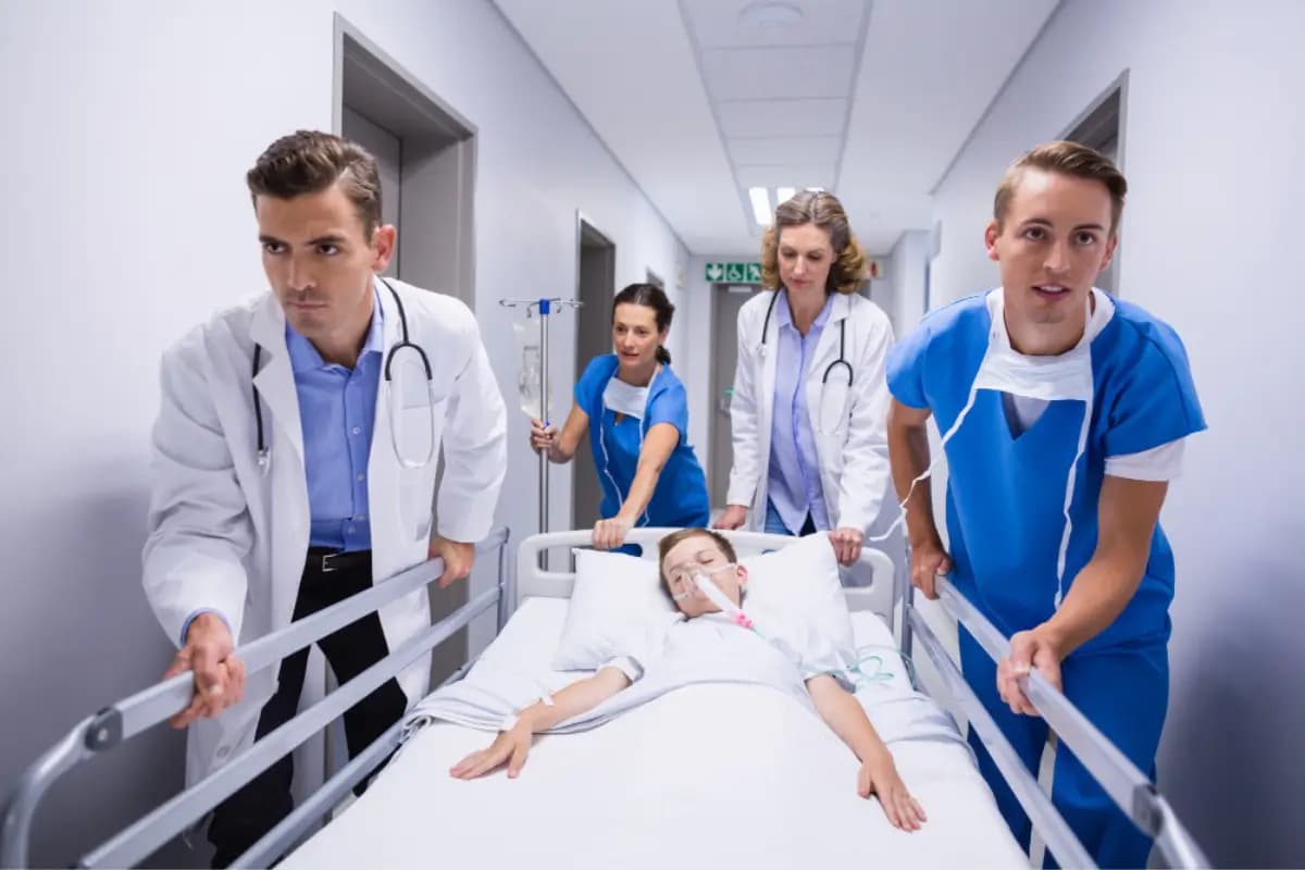 Emergency care team transporting a patient